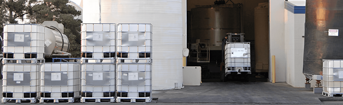 Large containers stacked beside a warehouse