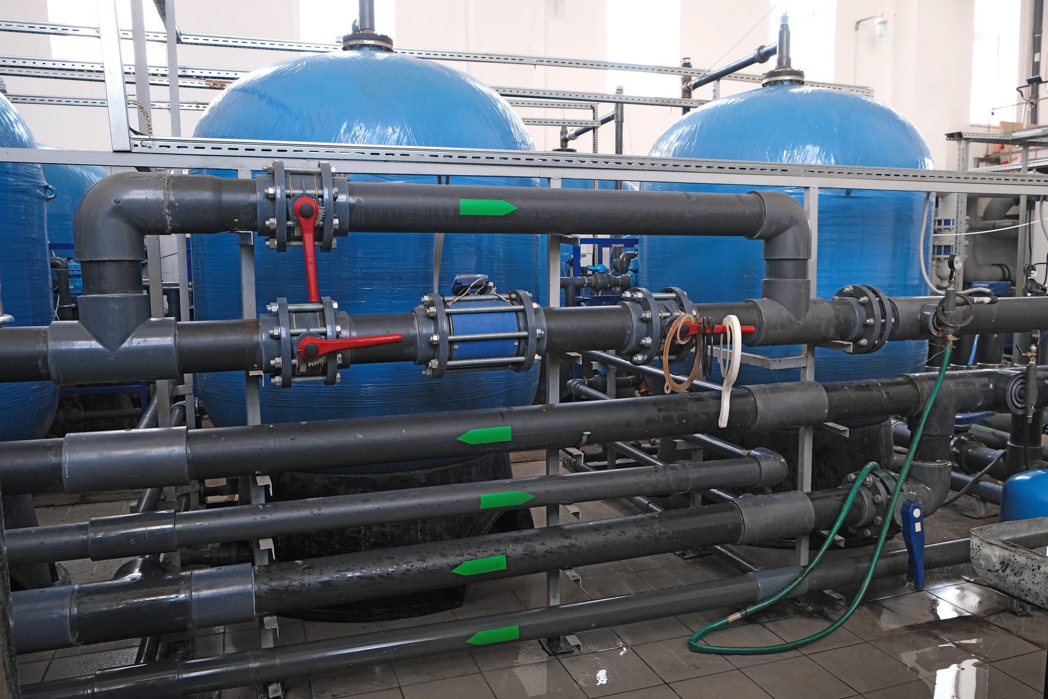 many water pipes and tanks with valves and faucets, wastewater treatment facilities indoors, industrial interior