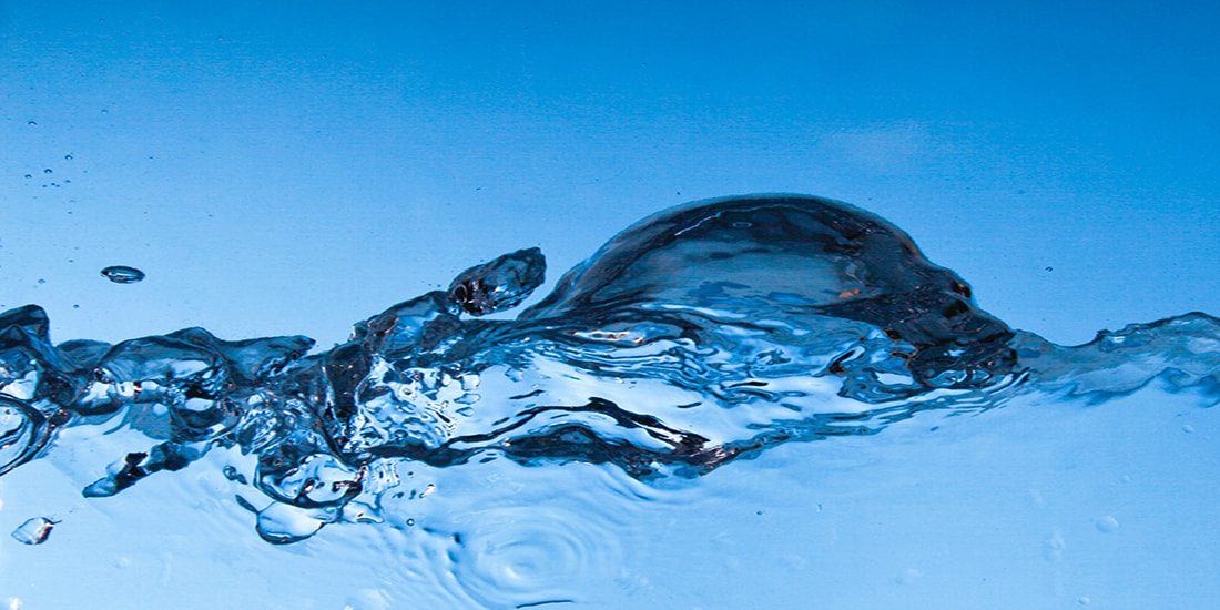Clear water splash against blue background.